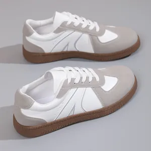 Retro German army sneakers featuring a white and grey leather design with classic brown gum soles.