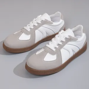 Detailed side view of retro white German Army Trainers with grey suede panels and gum sole.