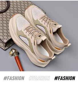 Detailed view of cream thick-soled leisure sneakers on a gray surface with fashion props