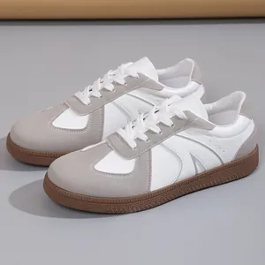 Side view of retro German Army Trainers with white leather, grey suede and gum soles