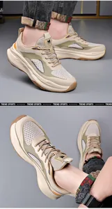 Detail view of stylish beige chunky men's sneakers with breathable mesh and foam sole