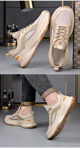 Close-up detail of men's beige chunky sneakers showing stylish design and on-foot look
