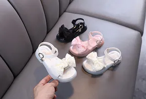 Detailed view of princess girl's summer sandals with lace bows in three colors