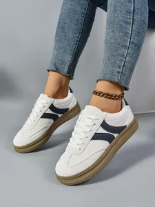 Λεπτομερής προβολή μοντέρνων sneakers πλατφόρμας σε στυλ γερμανικής προπόνησης σε λευκό