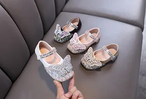 Detail view of sparkling butterfly and rhinestone embellishments on toddler girls shoes