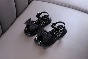 Black girls' princess sandals with a decorative lace bow and cute rabbit charm.