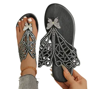 Elegant black flat flip-flop sandals for women with rhinestone butterfly design.