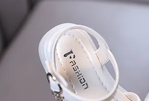 Detailed macro view of white children's sandal insole showing clean stitching and print