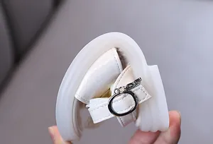 Detail view of white girls' leather sandal showing flexible soft sole for performance
