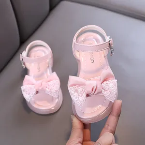 Sweet pink princess sandals for girls with elegant lace bow details and comfortable ankle strap