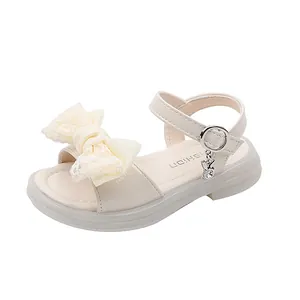 Beige girl's princess sandals featuring a large lace bow and cute rabbit charm detail
