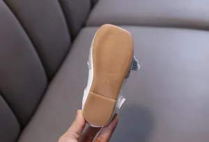 Detailed view of non-slip rubber sole for girls' white rhinestone princess shoes