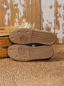 Detaillierte Nahaufnahme der rutschfesten Gummisohle grüner Retro-GAT-Sneaker-Schuhe