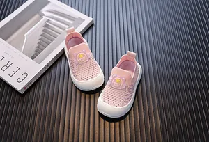 Detail view of breathable pink fly-knit mesh toddler shoes with a soft slip-on design.