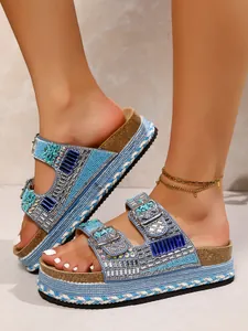 Detail view of blue rhinestone platform sandals with braided hemp rope and cork sole