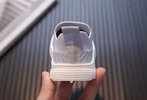 Heel view of breathable fly-knit toddler walking shoe with soft anti-slip sole