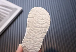 Detailed macro view of the white anti-slip wavy sole texture for toddler walking shoes