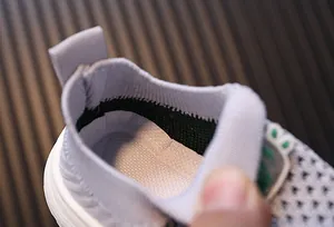 Close-up of the breathable knit interior and soft collar of toddler walking shoes