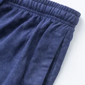 Close-up of the elastic waistband and pocket detail on blue tie-dye men's lounge shorts