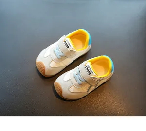 Detailed view of breathable toddler sneakers with yellow lining and blue laces