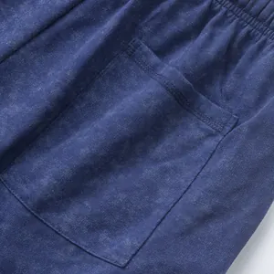 Macro view of vintage acid-wash navy blue french terry men's shorts showing pocket detail.
