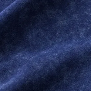 Close-up of premium navy blue tie-dye terry fabric texture for summer shorts