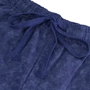 Close-up of tie-dye terry shorts showing elastic waistband and drawstring detail