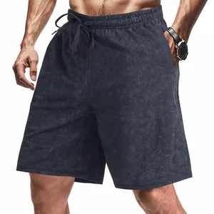 Close-up detail of men's loose tie-dye sweat shorts with adjustable drawstring waistband