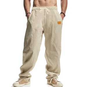 Close-up of the textured fabric and drawstring waist on these beige men's linen casual pants