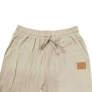 Close-up detail of beige men's breathable linen casual pants with drawstring waist