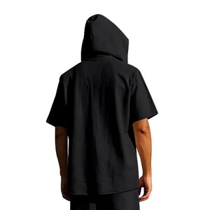 Detailed back view of a men's loose casual linen hooded short sleeve Henley shirt in black.