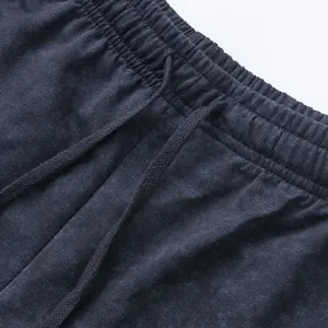Detail of tie-dye men's casual shorts with elastic waistband and drawstring cord.