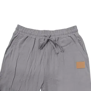 Close-up of grey linen casual trousers featuring a comfortable elastic drawstring waist