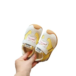 Breathable yellow and beige mesh baby walking shoes with soft soles and pink laces