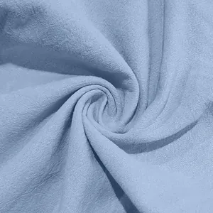 Macro view of light blue breathable linen fabric texture for men's summer beach pants