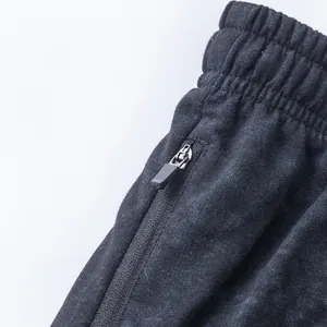 Close-up of elastic waistband and zipper pocket on men's tie-dye sweat shorts