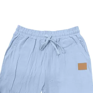 Close-up detail of men's blue linen pants featuring elastic drawstring waist and side pockets.