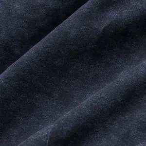 Macro detail of dark washed tie-dye french terry cotton fabric for men's shorts