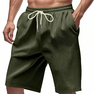 Close-up detail of men's olive green heavyweight corduroy shorts with elastic drawstring waist