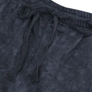 Detailed macro view of the elastic waistband and woven drawstring on gray tie-dye shorts
