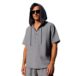 Close-up detail of a grey linen hooded Henley shirt with wooden buttons and drawstrings