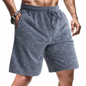Close-up of men's casual shorts featuring a grey tie-dye texture and zip pockets