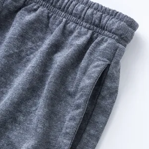 Detailed close-up of grey marl men's sports shorts showing elastic waistband and side pocket