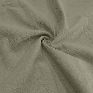 Close-up of breathable olive green linen fabric texture for men's summer beach outfit