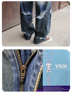 Gros plan sur un jean bleu délavé avec une fermeture éclair métallique YKK de qualité