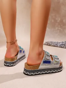 Close-up detail of luxury rhinestone platform sandals featuring cork soles and rope trim