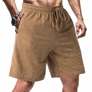 Detailed view of men's brown tie-dye casual shorts featuring a drawstring waist and zipper pocket.