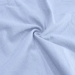 Macro view showing the breathable light blue linen fabric texture for summer menswear