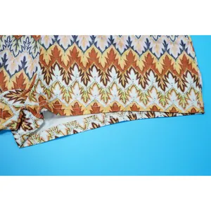 Detailed close-up showing colorful wavy pattern and stitching on female summer romper
