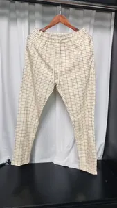 Detail van een lichte herenzomerbroek met een trendy en stijlvol ruitjespatroon.
